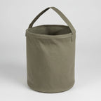 Green fabric bucket with handle on a white background