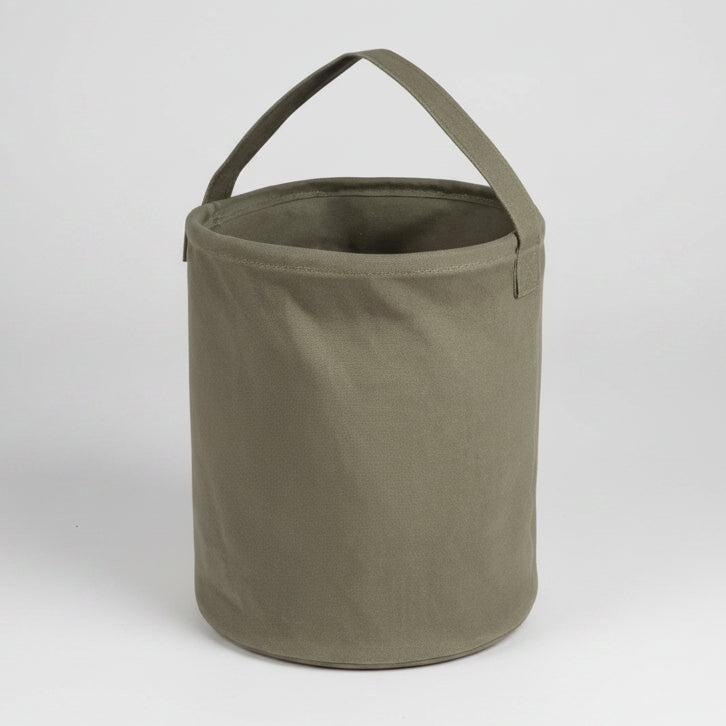 Green fabric bucket with handle on a white background