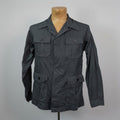 Dark gray jacket on a mannequin against a plain background