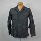 Dark gray jacket on a mannequin against a plain background