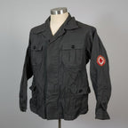 Black jacket with a red cross emblem on a mannequin against a gray background
